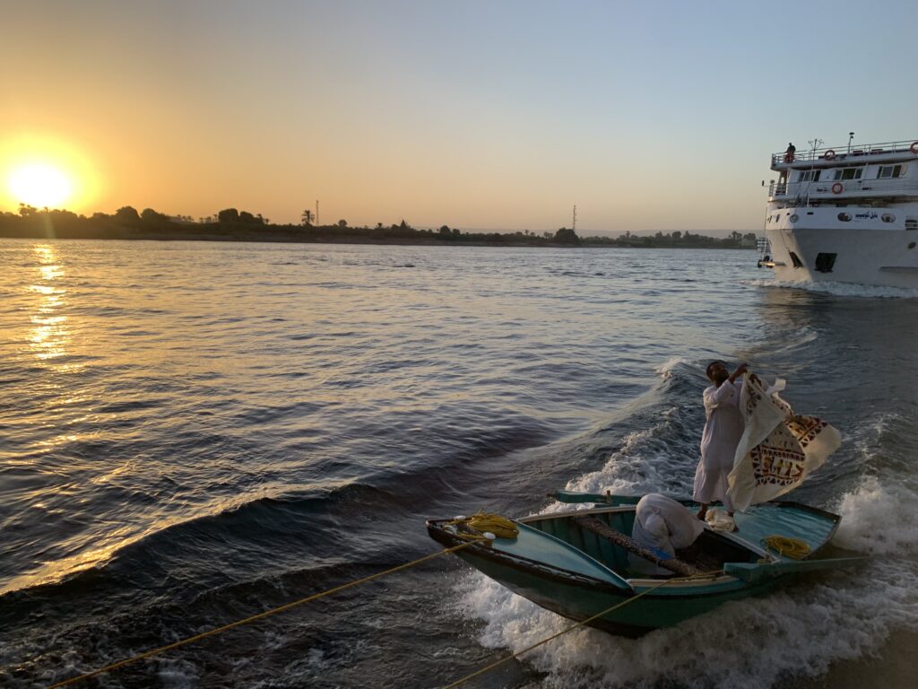 Tourist enjoying a Nile cruise at sunset in Egypt