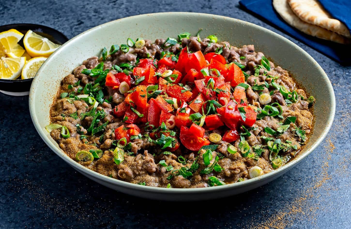 Plate of Ful Medames with toppings and bread